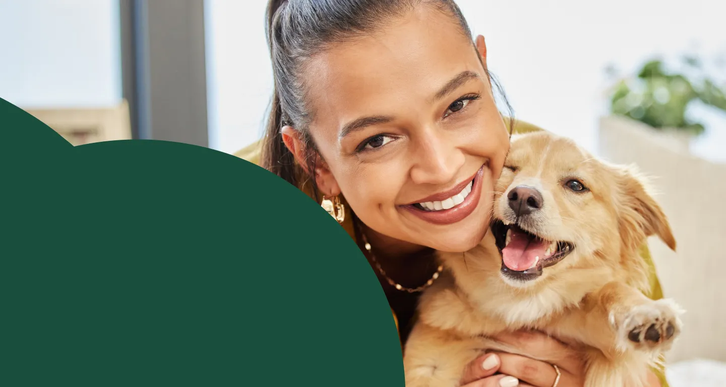 Woman holding a golden retriever dog